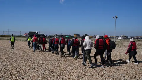 PA Media A group of people thought to be migrants are brought in to Dungeness, Kent, by the RNLI, following a small boat incident in the Channel. Picture date: Tuesday April 4, 2023.