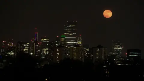 Justin Tallis/Getty Images The full moon of April, called the Super Pink Moon, rises over the skyline of London