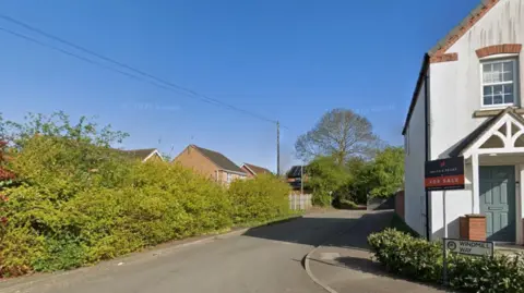 Mill Lane Huthwaite - a small road in a relatively new estate which runs alongside a hedge before becoming a tree and hedge lined country lane.