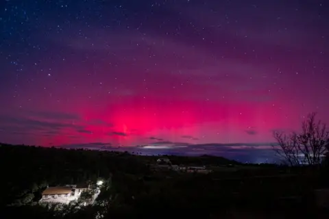 Lorena Sopena/Europa Press via Getty Images An aurora borealis from the Castelltallat astronomical observatory, on October 10, 2024, in Catelltallat, Barcelona, Catalonia, Spain. 