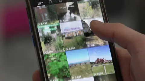 A smartphone held up by a person showing someone scrolling with their thumb through a TikTok account full of videos of urban exploring. 
