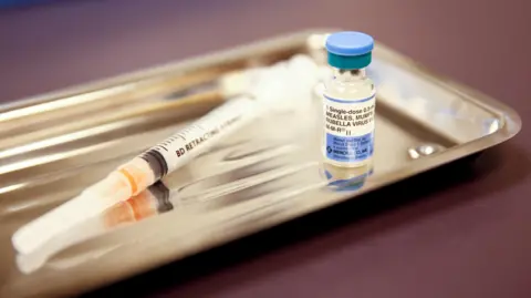 Reuters  Measles vaccine and syringe 