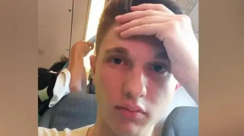 Sam Williamson Selfie of annoyed Sam Williamson on the train after he was told he would be prosecuted