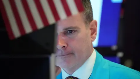 AFP Traders work on the floor at the opening bell of the Dow Industrial Average at the New York Stock Exchange on March 18, 2020 in New York.