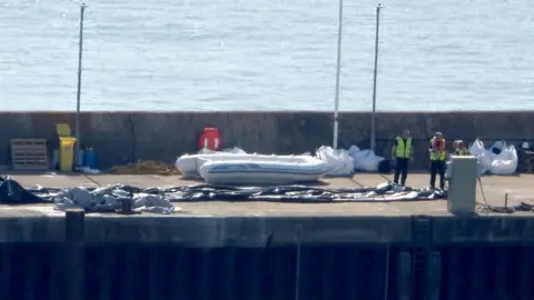 A deflated dinghy is seen on the quayside in Dover, Kent. A record 230 migrants arrived after crossing the Channel to the UK in a single boat on Monday