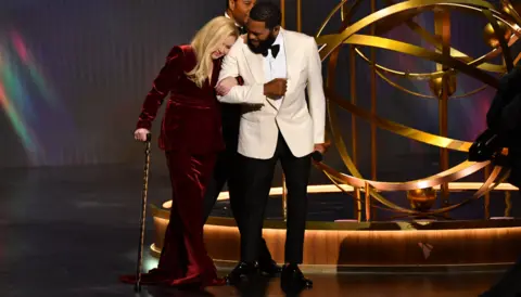 Getty Images Actor Anthony Anderson and US actress Christina Applegate arrive onstage during the 75th Emmy Awards at the Peacock Theatre at L.A. Live in Los Angeles on January 15, 2024