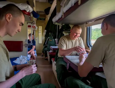 Peter Dench Army recruits play cards