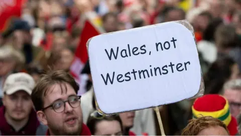 Getty Images Protester holding a sign saying "Wales, not Westminster"