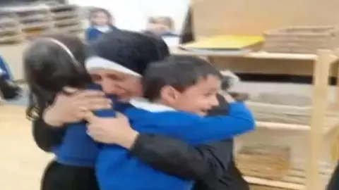 Islam Alashi hugs her twins