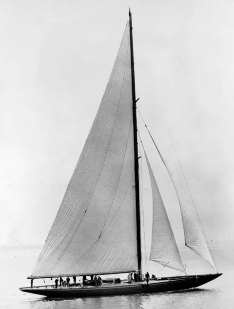 Roger Viollet Collection/Getty A black and white image of a racing yacht