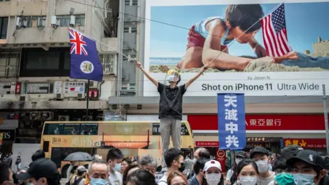 Getty Images A protestor waving the US and Hong Kong colonial-era flags