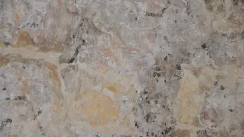 HB Archaeology & Conservation Limited A photo of a faded wall painting on a stone wall
