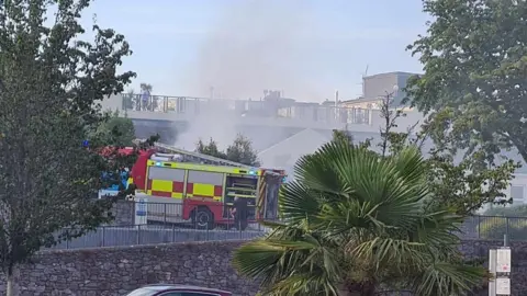 Kevin Oates Firefighters tackling a blaze in a car park