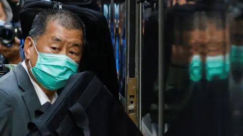 Reuters Jimmy Lai, founder of Apple Daily, looks on as he leaves the Court of Final Appeal by prison van, in Hong Kong in 2021