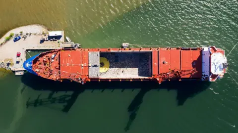 Hexatronic An aerial view of an industrial cable laying vessel