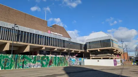 An external view of the Assembly Rooms in Derby showing barriers to prevent access.