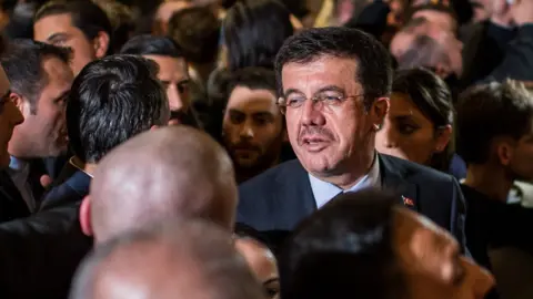 Getty Images Turkish Economy Minister Nihat Zeybekci talks to Turkish people in Cologne, Germany on 5 March.