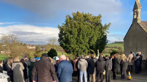 Mourners gather at the funeral 