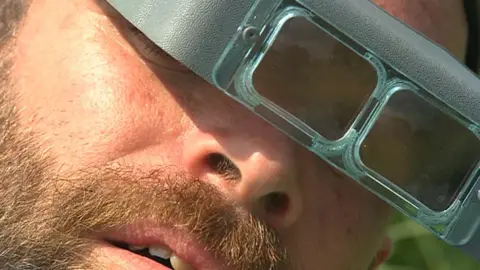 Man in magnifying goggles