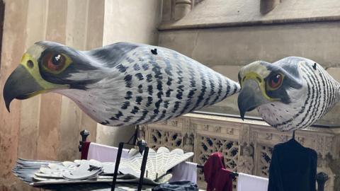 A pair of peregrine falcon puppets at St Albans Cathedral