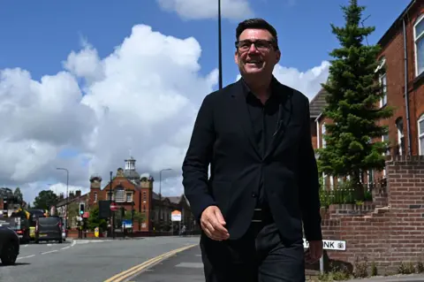 Getty Images Andy Burnham walks down a street in Makerfield, Manchester 