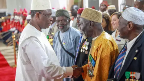 Presidency of Senegal/Getty Images Senegalese President Macky Sall meets with "Senegalese Snipers" after they returned to their country in Dakar, Senegal on April 29, 2023