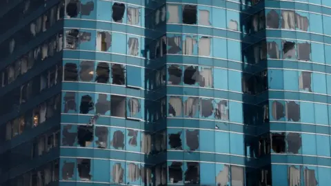 Reuters A high-rise Hong Kong building has dozens of smashed windows