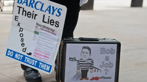 Getty Images Cartoon of Bob Diamond on protestor's briefcase