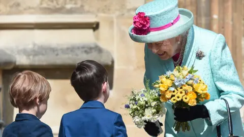 PA The Queen was presented with flowers as she left St George's Chapel