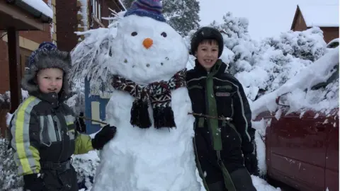 Alexandra Stephens Two boys with a snowman