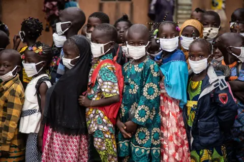 OLYMPIA DE MAISMONT / AFP A crowd of children wearing face masks
