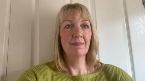 Supplied A woman in front of a door