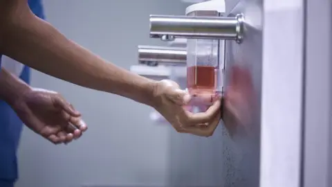 Getty Images A medic washing their hands in a hospital