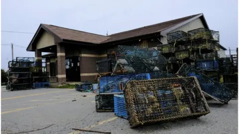 Reuters Lobster traps that were seized by non-native fishers lie dumped outside the DFO office