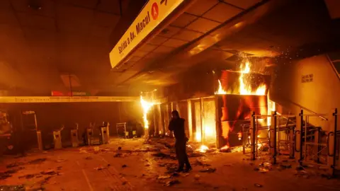 Reuters A subway ticket office is seen on fire during a protest against the increase in the subway ticket prices in Santiago