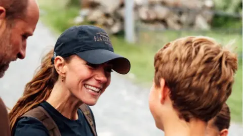 Instagram/princeandprincessofwales Kate smiles at George who has his back to the camera as William looks on
