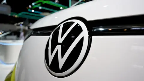 Getty Images VW badge on a white Volkswagen car