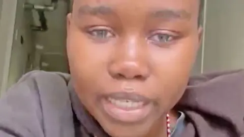 Basetsana Mathipa A girl with very short hair looks at the camera crying