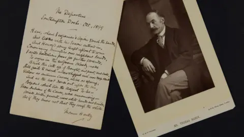 Dorset History Centre Thomas Hardy's The Departure in fountain pen handwriting next to a black and white photo of the author