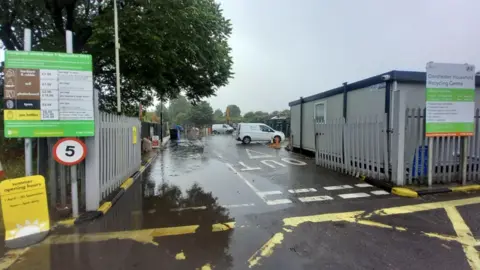 The entrance to a household recycling centre on a cloudy day