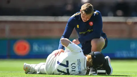 Jordan Cox receives treatment from physio