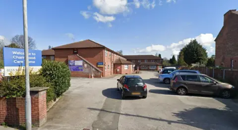 Google A Streetview image of Charnwood Care Home, a two storey brick building within a car park area, surrounded by residential houses