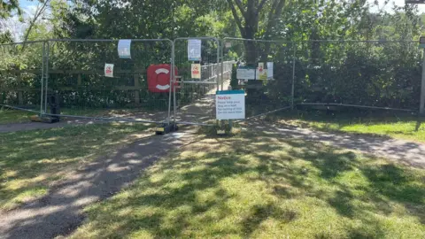 LDRS/Emily Dalton The entrance to a woodland is fenced off and there is a notice by the fence.