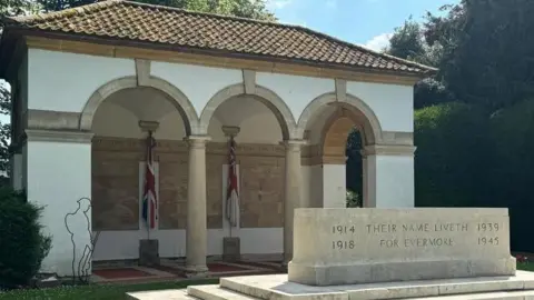 A stone of remembrance on a three-stepped base. The words "Their name liveth for evermore" is inscribed on the stone, as are the dates of both world wars.