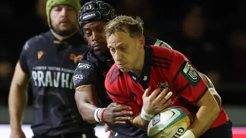 Mike Haley is tackle by Daniel Kasende