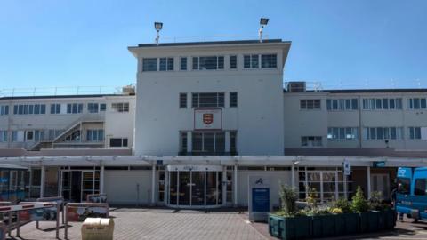 The front entrance to Jersey airport with a view of the arrivals area