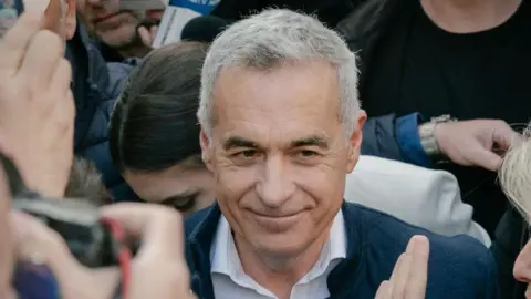 Getty Images Calin Georgescu smiling and surrounded by people