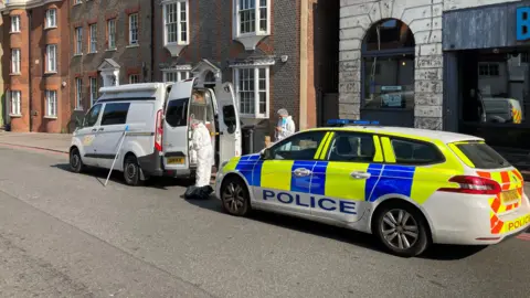 Patrick Jackson/BBC Picture of forensic officers taken from western side of stabbing scene