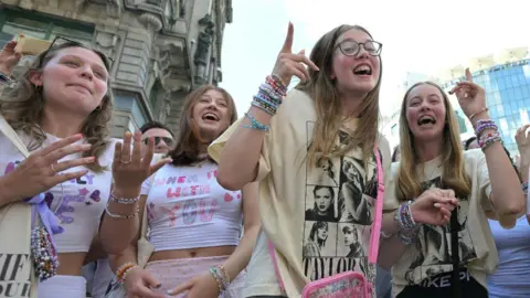 Getty Images A group of young Taylor Swift fans singing on the streets of Vienna