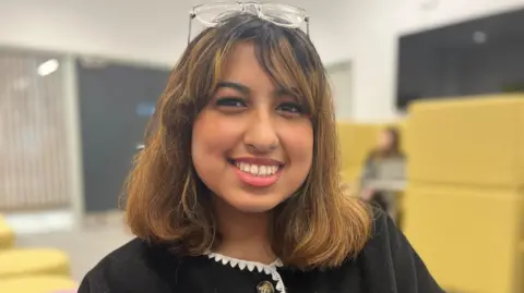 Nicola Haseler/BBC Amira smiling at the camera